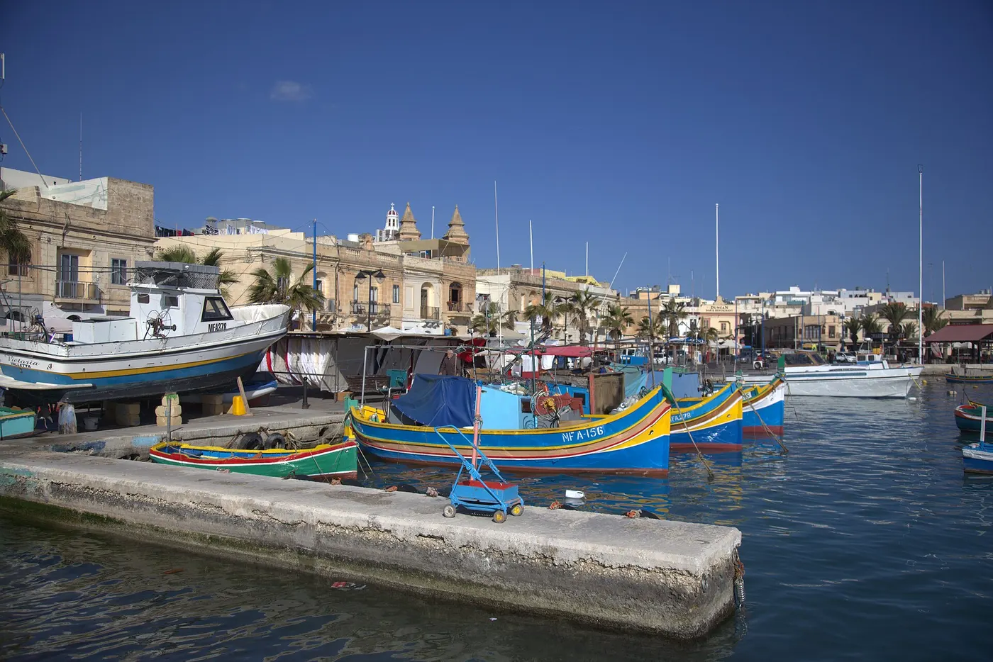 Traditional painted fishing boats in Marsaxlokk harbour, Malta