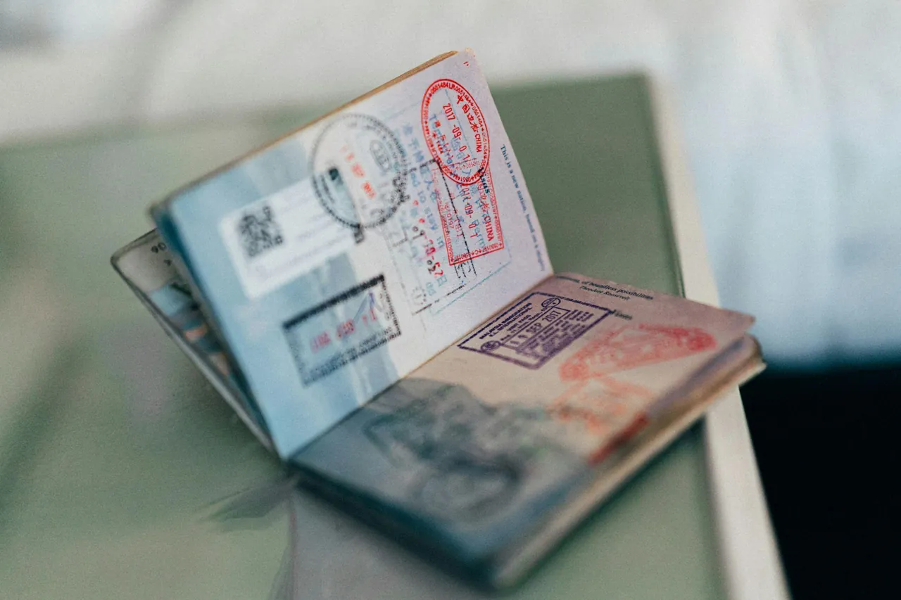 An open passport with entry stamps