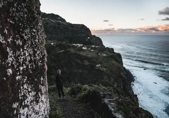 A walker on a cliff path above the north coast of Madeira