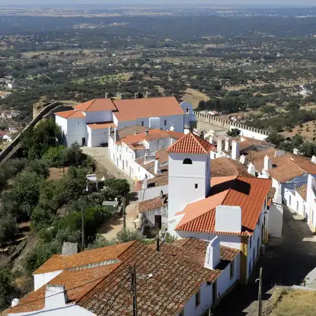A whitewashed walled hill town looking out over the Alentejo