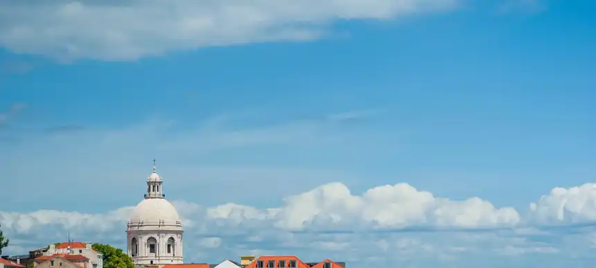 Terracotta rooftops of Alfama with the Tagus beyond