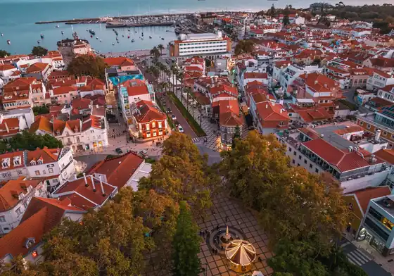 Terracotta rooftops, the marina and the square at Cascais at dusk